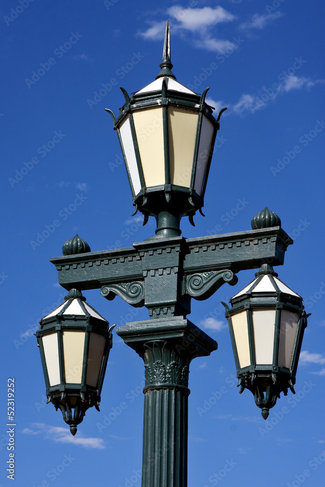 old green street lamp and clouds