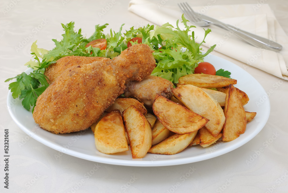 Chicken drumsticks with breadcrumbs with potatoes and salad Chicken drumsticks with breadcrumbs with potatoes and salad