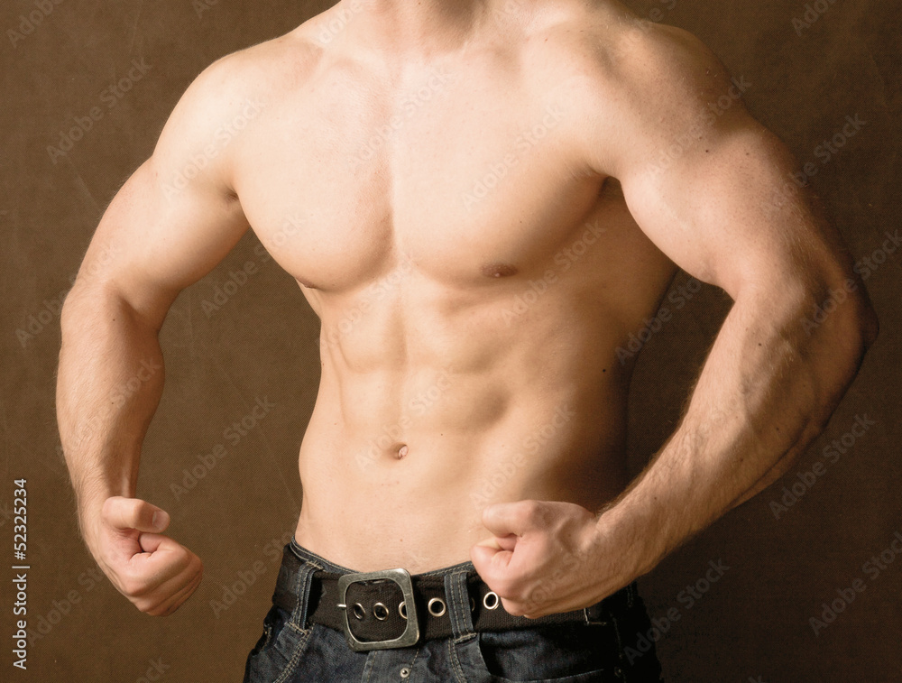 Muscular man, isolated on brown background