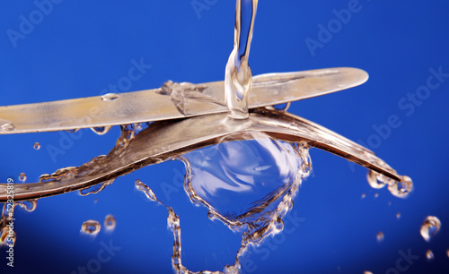 cutlery under running water.