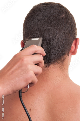 Man having a haircut with a hair clippers over a white backgroun