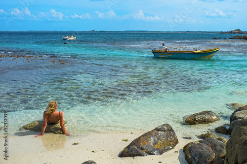 Woman sun bathing in Pigeon island