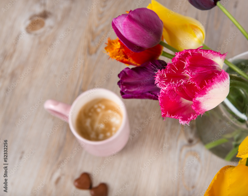 Colorful tulips and a cup of fresh coffee Colorful tulips and a cup of fresh coffee