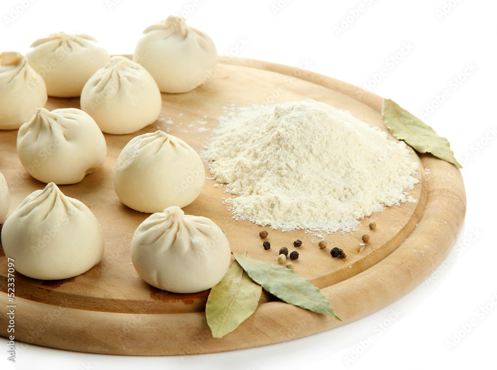 Raw khinkali on wooden desk, isolated on white Raw khinkali on wooden desk, isolated on white