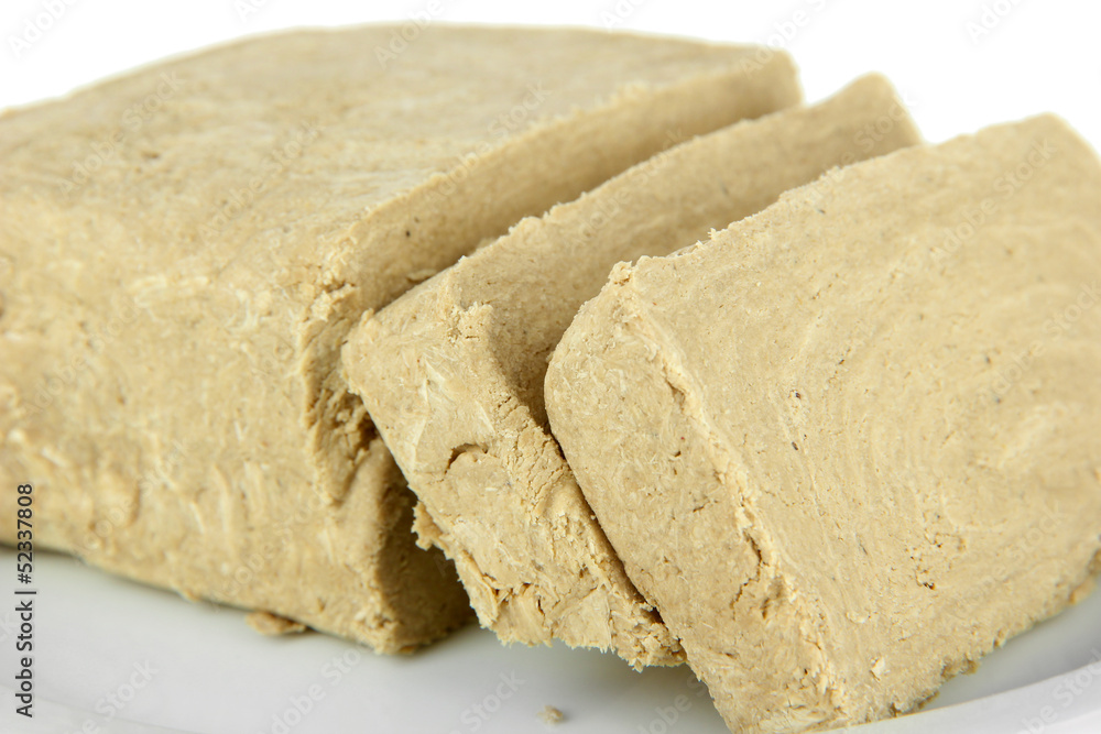Tasty halva on plate isolated on white Tasty halva on plate isolated on white