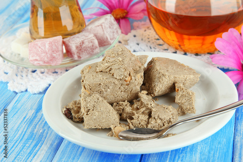 Tasty halva with tea on table