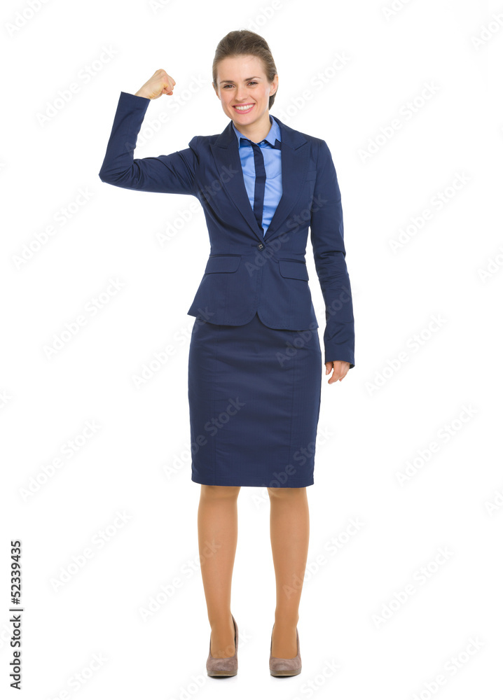 Full length portrait of happy business woman showing biceps Full length portrait of happy business woman showing biceps