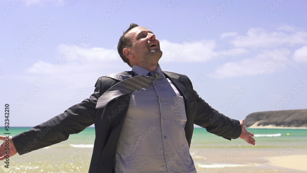 Happy young businessman on beautiful exotic beach