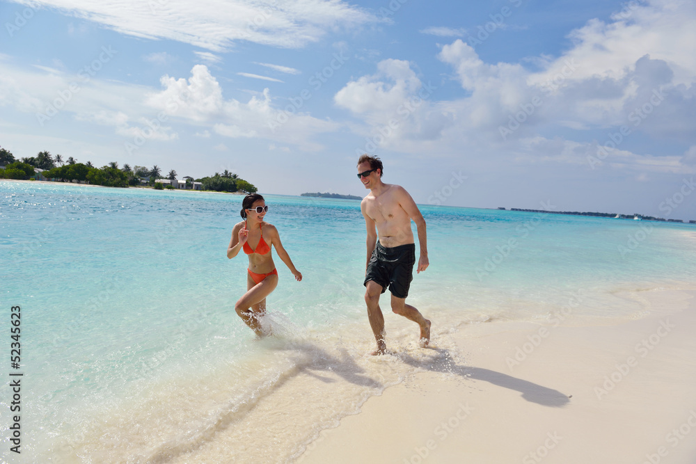 happy young couple have fun on beach