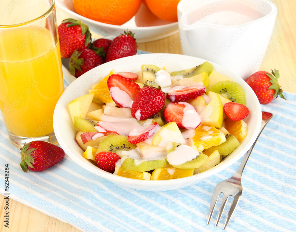 Useful fruit salad of fresh fruits and berries in bowl Useful fruit salad of fresh fruits and berries in bowl