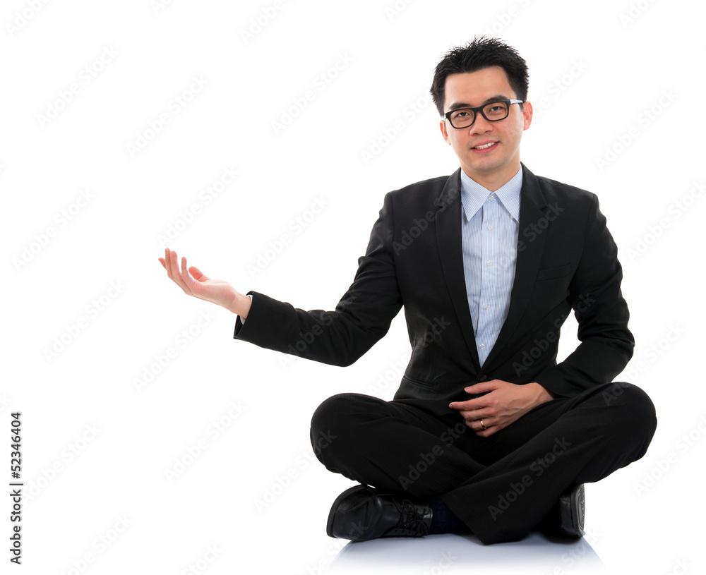 Asian business man showing blank space sit on floor Asian business man showing blank space sit on floor