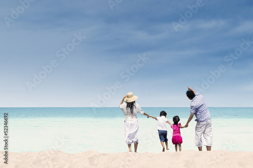 Happy family at white sand beach, Australia