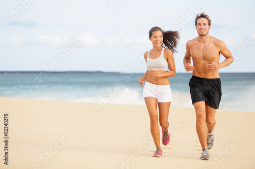 Runners - Young couple running on beach