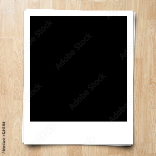 blank photo frame on brown wood plank background