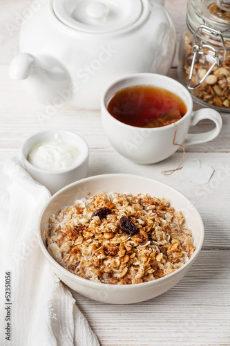 Muesli granola with raisin and yogourt in white bowl © Natalia Lisovskaya
