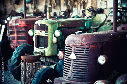 Fotografie Old abandoned farm tractors. obsolescence and past concept