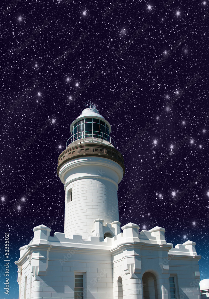 Lighthouse upward view against starry sky