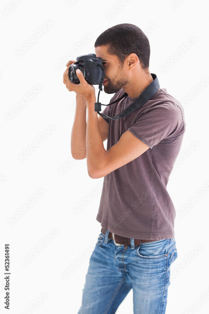 Stylish man taking photograph with digital camera Stylish man taking photograph with digital camera