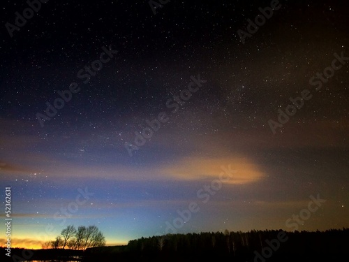 The Milky Way rotates around the pole star, then dawn. photo