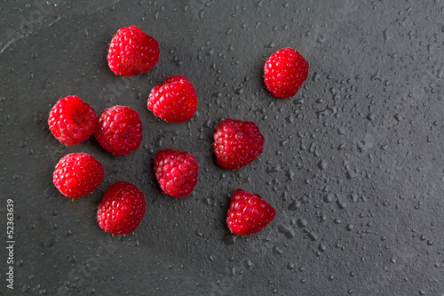berries raspberry on black slate background