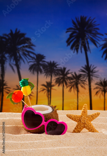 Coconut cocktail on tropical sand beach heart sunglasses