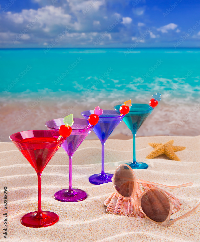 colorful cocktail in a row with cherry on tropical sand beach colorful cocktail in a row with cherry on tropical sand beach