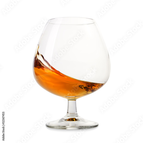 Cognac splashes in a glass