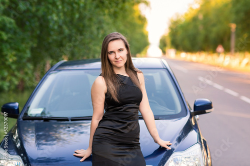 Beautiful businesswoman near her car