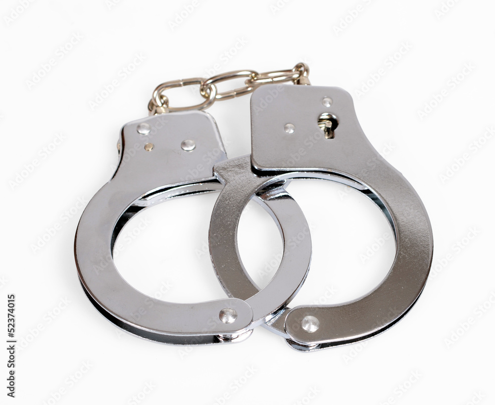 A pair of handcuffs isolated over white with clipping path A pair of handcuffs isolated over white with clipping path