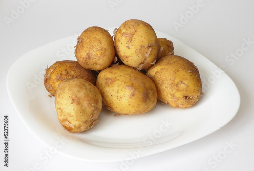 Fresh potatoes on the plate.