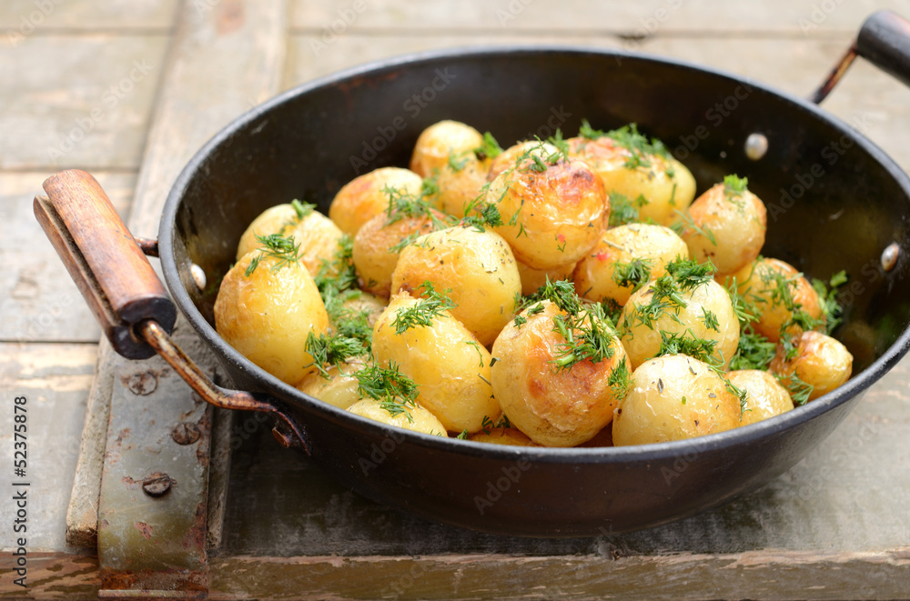 Whole fried potato in old wok Whole fried potato in old wok