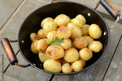 Whole fried young potato with rosemary