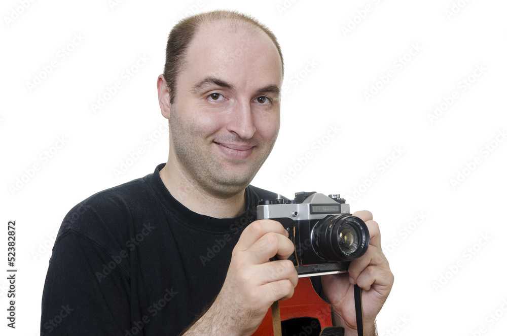 young man holding a vintage camera on white background