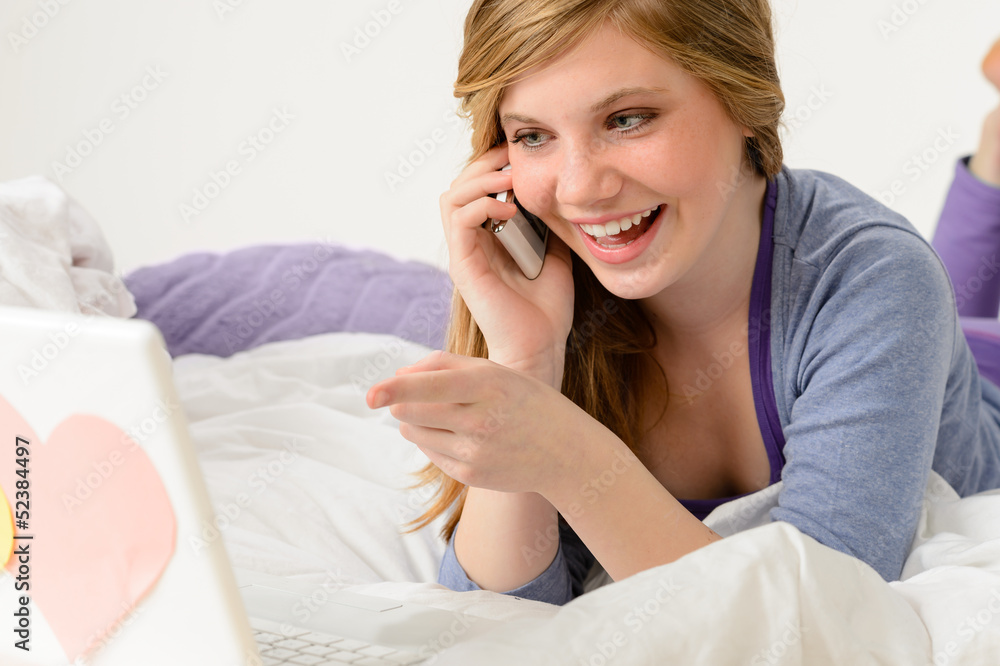 Laughing teenager relaxing by speaking on phone Laughing teenager relaxing by speaking on phone