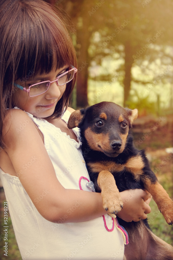 Happy little girl holding her dog Happy little girl holding her dog
