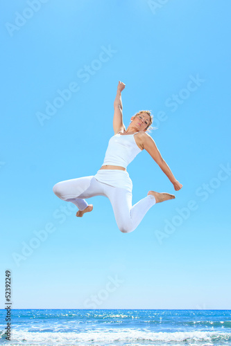 woman jumping on the beach