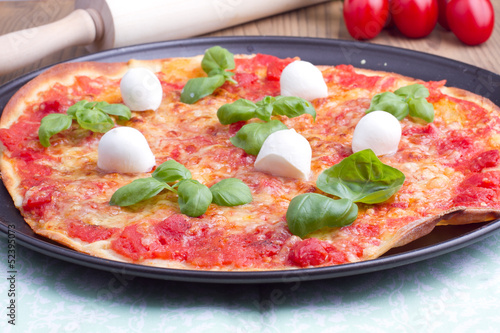 Pizza with mozarella and basil