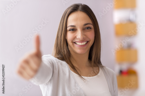 Wallpaper Mural Happy female smiling with her thumbs up Torontodigital.ca