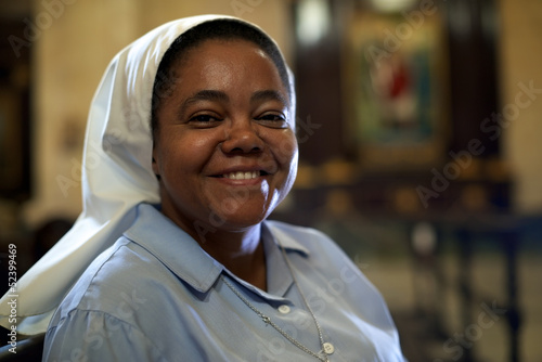 Woman and spirituality, portrait of catholic nun praying in chur
