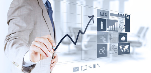 businessman hand working with new modern computer and business graph.