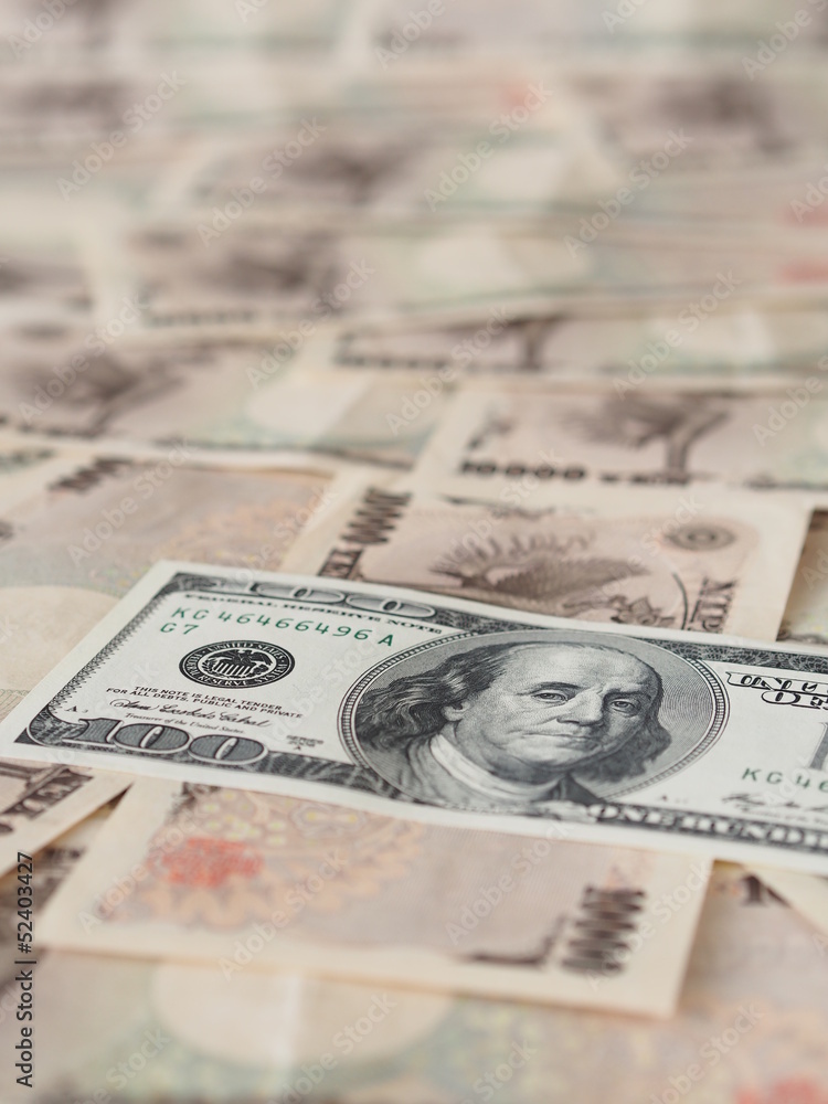 100 US dollar note isolated on Japanese yen note background 100 US dollar note isolated on Japanese yen note background