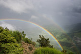 Double rainbow over hills