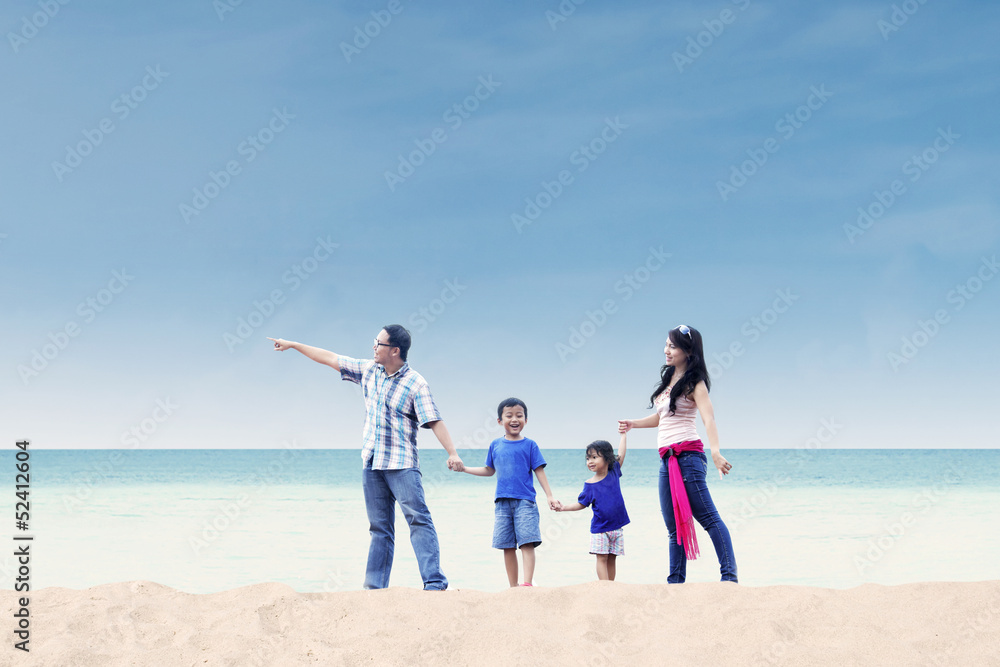 Asian family enjoy holiday at beach