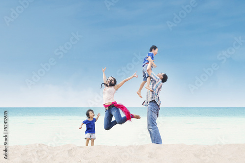 Asian family enjoy time at beach