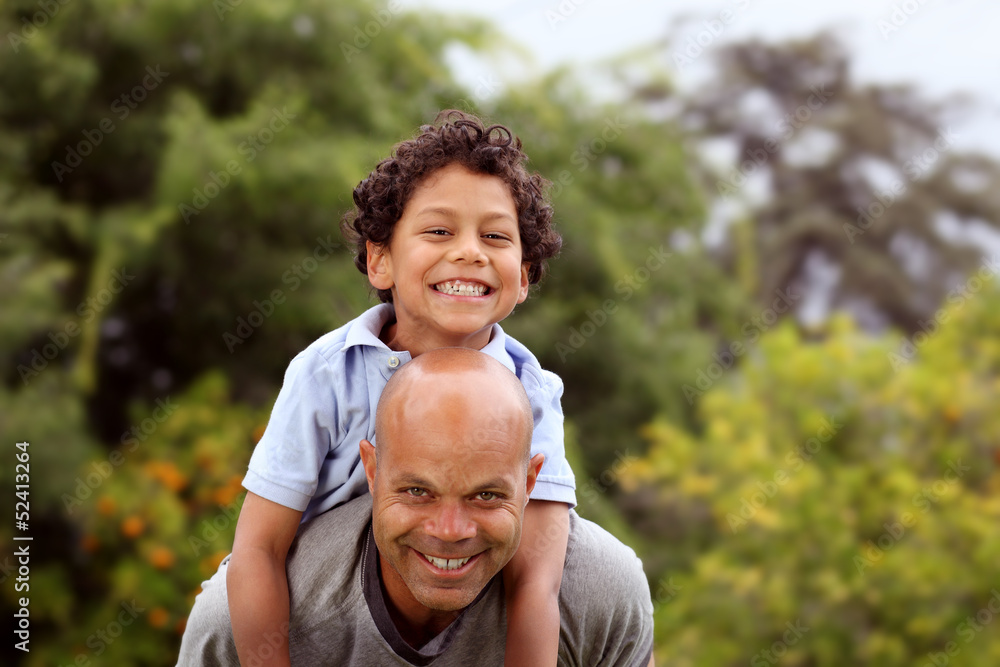 Mixed race father and son playing in the back garden Mixed race father and son playing in the back garden