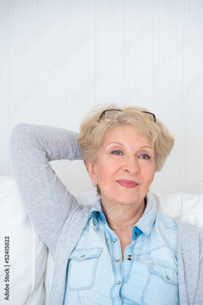 Smiling happy senior woman relaxing at home Smiling happy senior woman relaxing at home