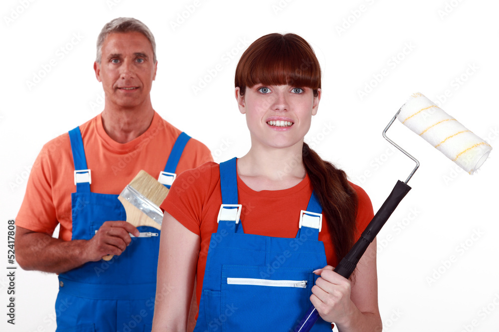 painters in overalls holding brushes