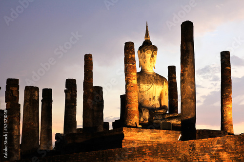 Ancient buddha statue at twilight, Wat Mahathat in Sukhothai His