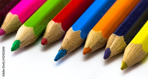 Close up of different color crayons on white