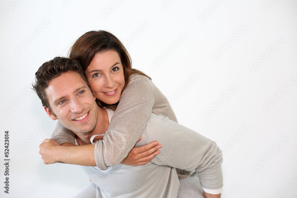 Handsome guy giving piggyback ride to girlfriend